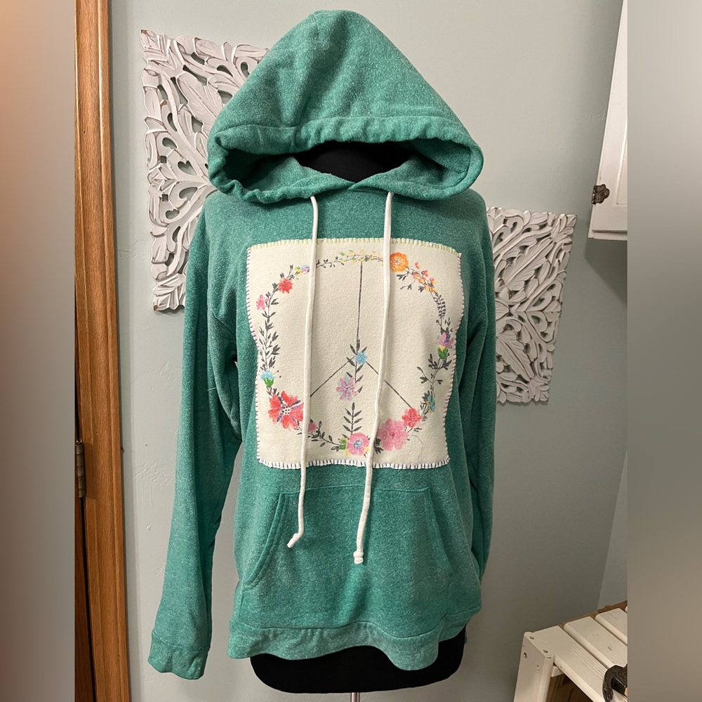 Women teal green sweatshirt up-cycled and hand sewn to add peace symbol.